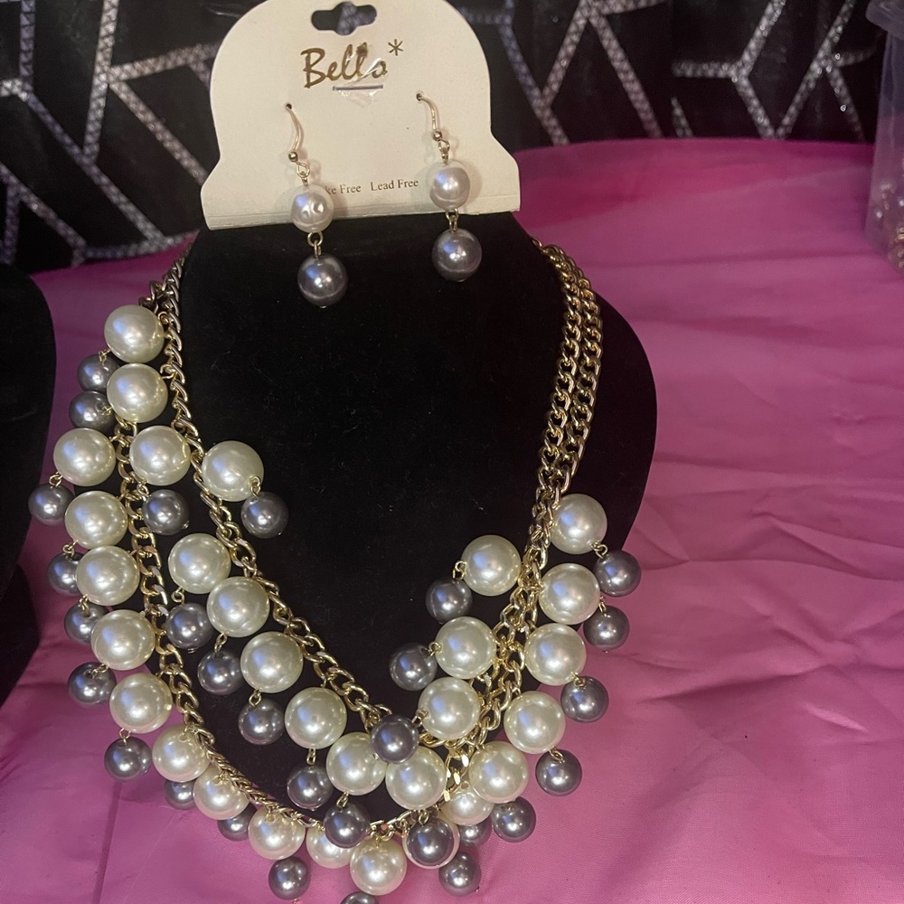 Woman’s pearl necklace, earring set